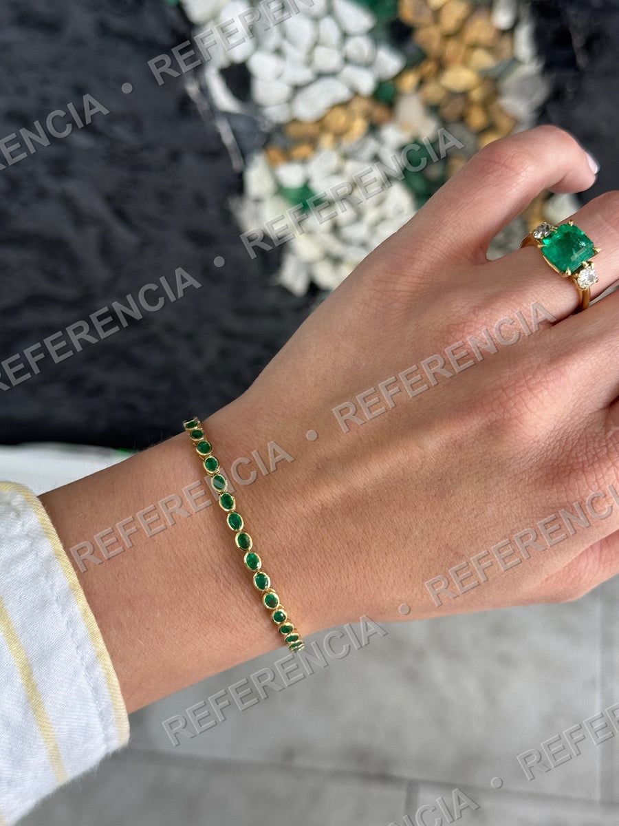 Emerald bracelet and ring on a hand